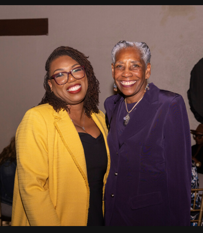 LaKeysha Cobbs-Hayes in a yellow blazer smiling beside Mrs. Brown in a purple blazer