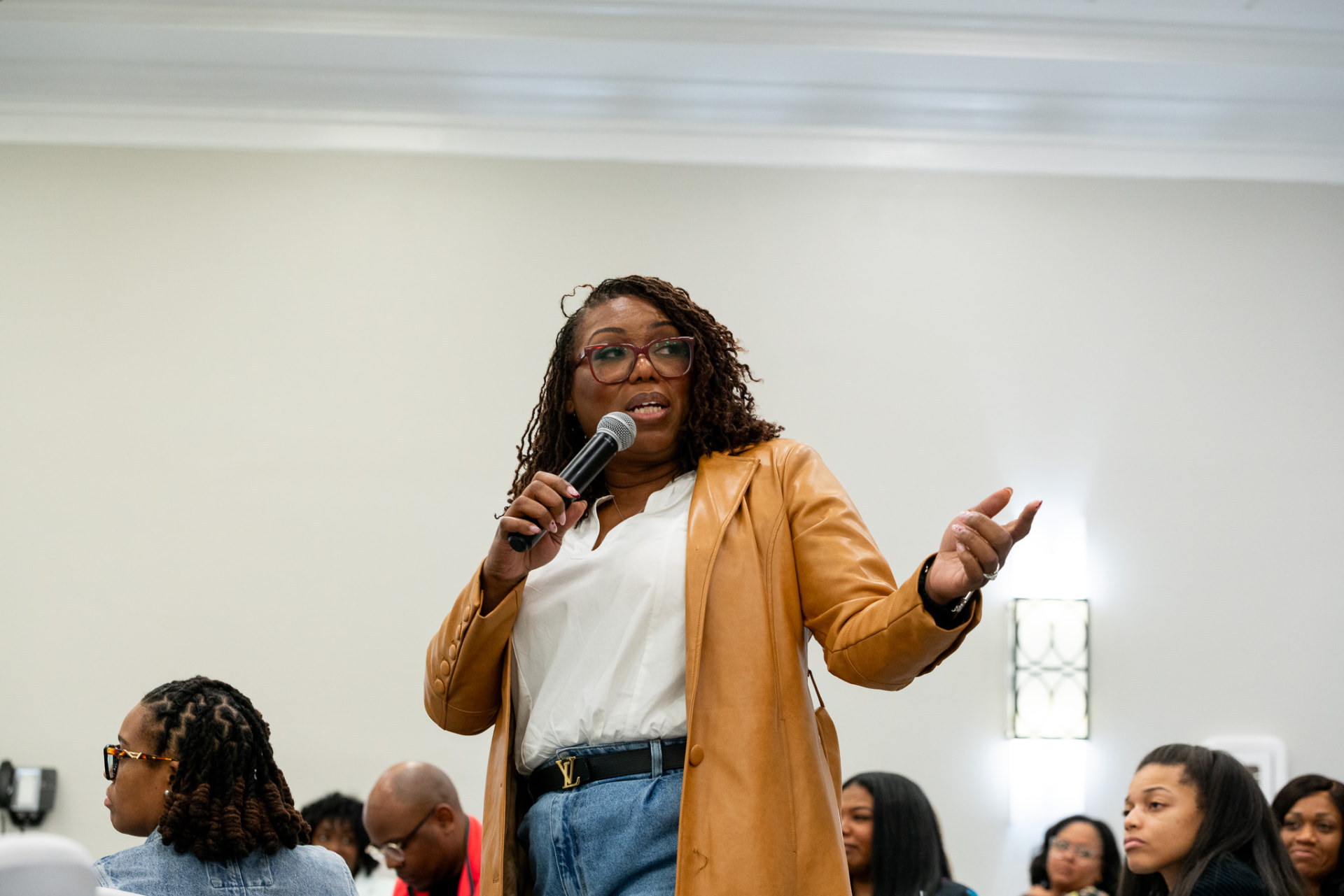 Coach Key addressing a seated audience during a workshop session