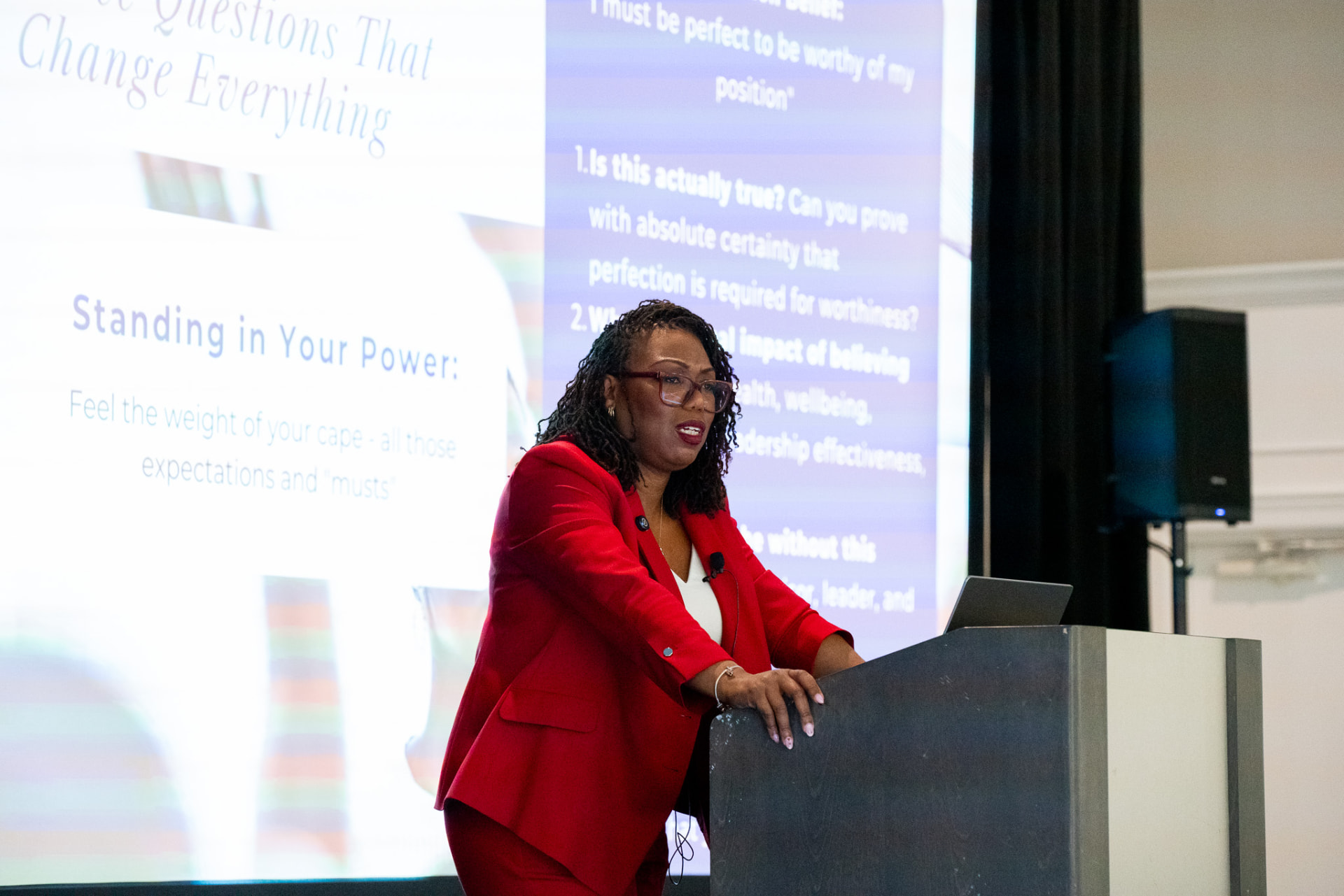 Coach Key presenting a slide titled Standing in Your Power at a lectern